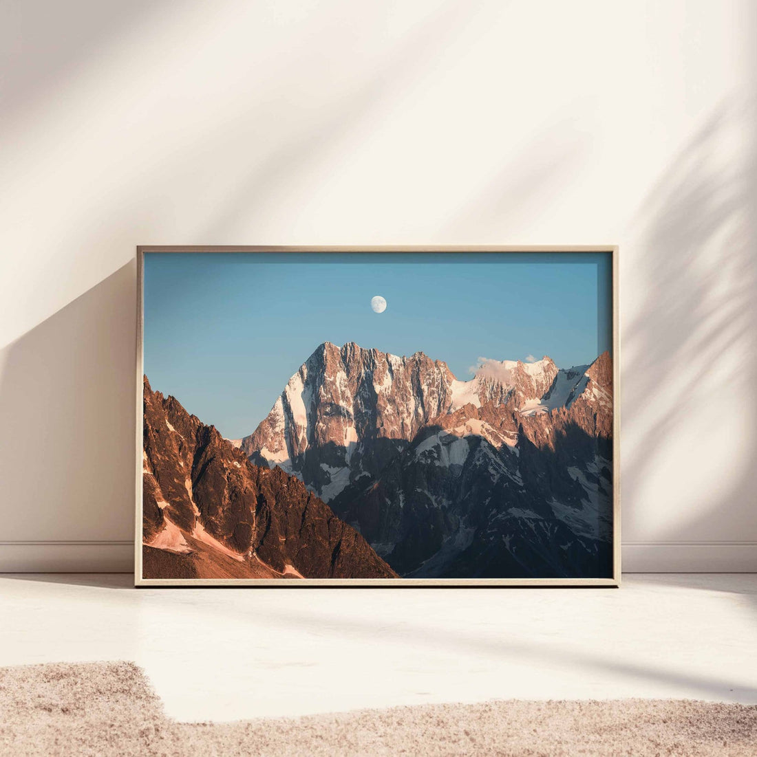 Grandes Jorasses print with rocky peaks and moon, wooden frame, in a bright studio setting