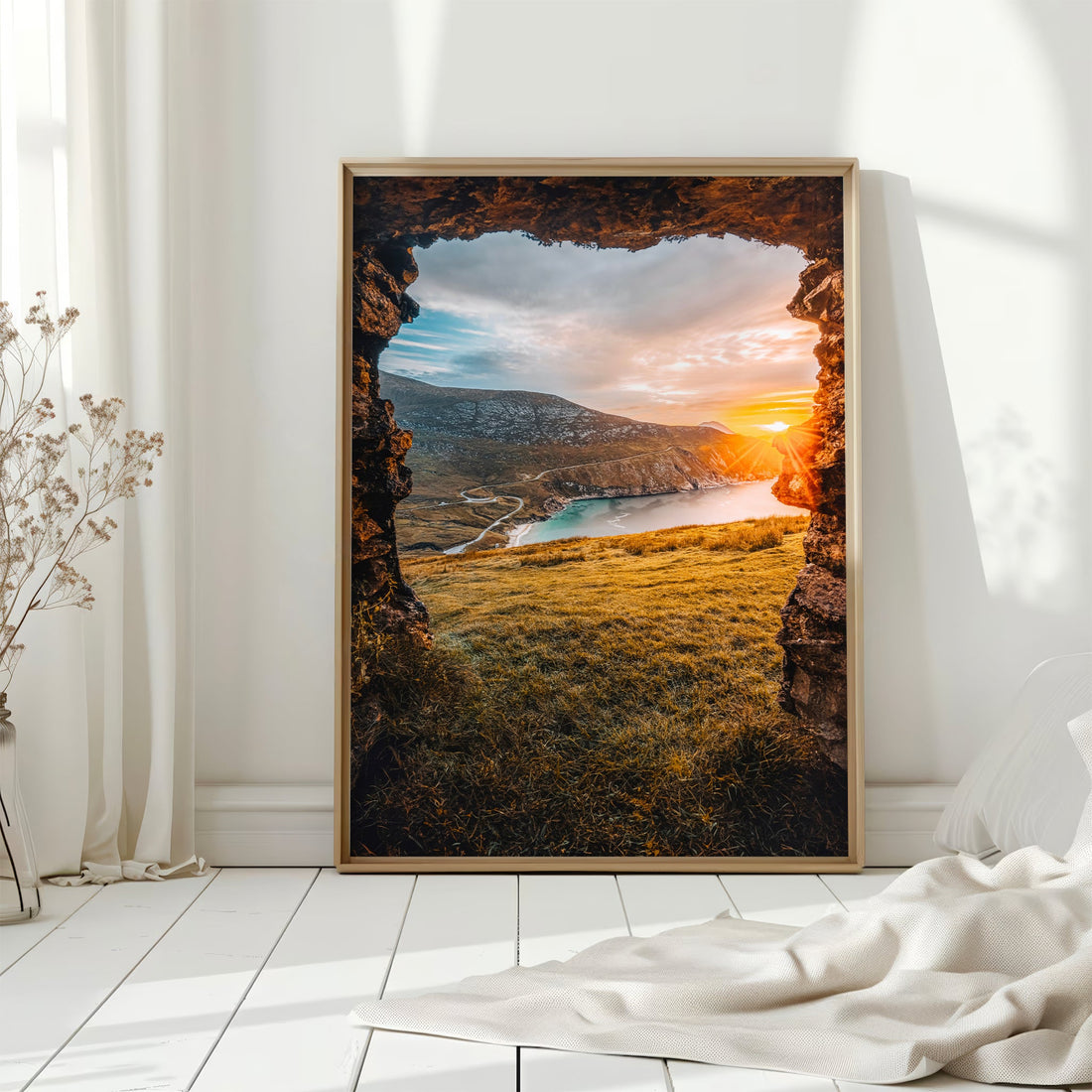 Golden light over Keem Beach on Achill Island with sea cliffs and winding road.