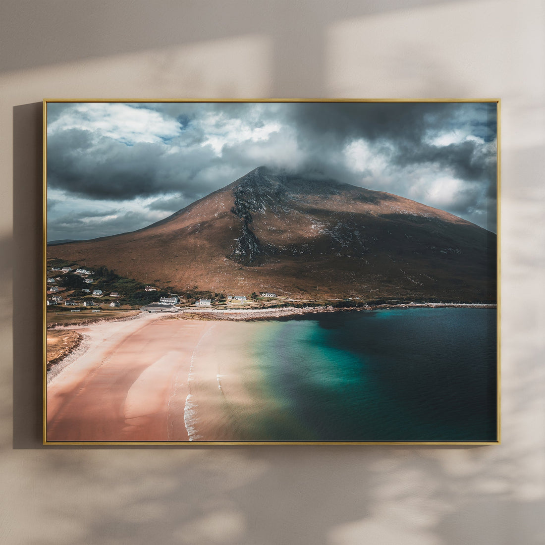 Framed aerial photo print of Dugort Beach on Achill Island, Ireland, with moody clouds and calm sea.