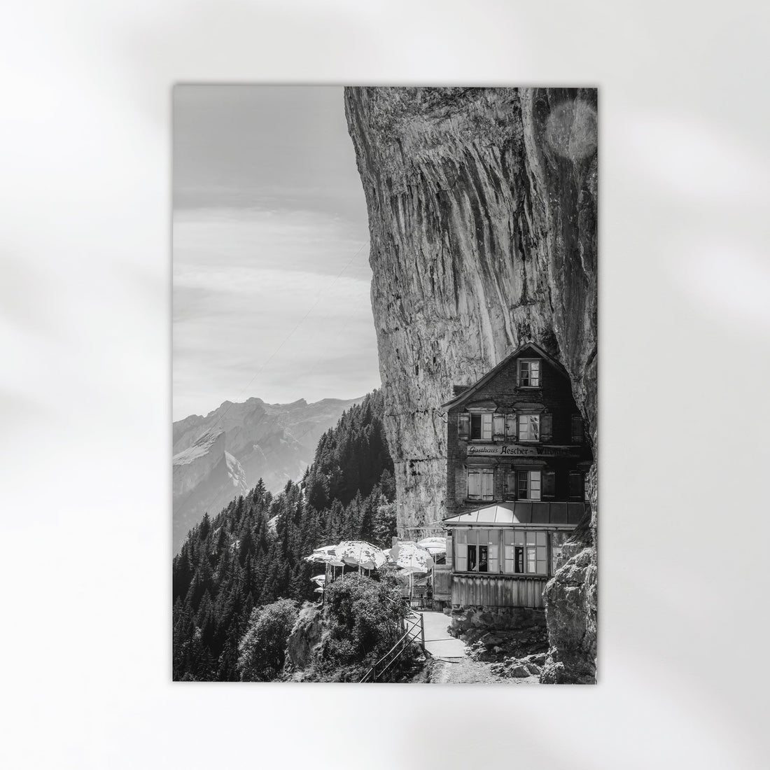 Stunning black-and-white print of Aescher Guesthouse, a famous Swiss cliffside hotel in the Alps.