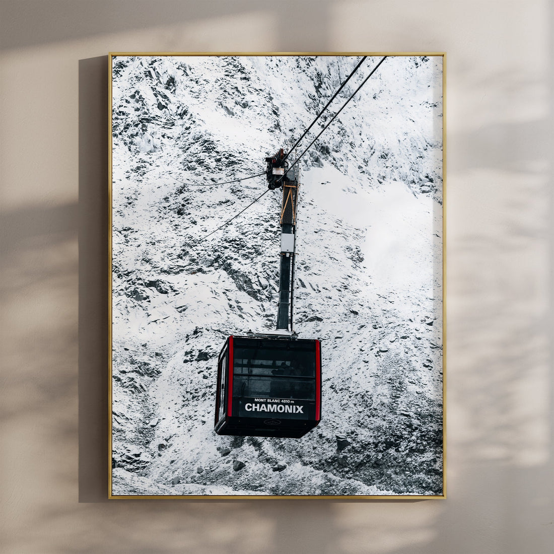 Aiguille du Midi cable car soaring over the snowy Mont Blanc landscape in Chamonix, France.