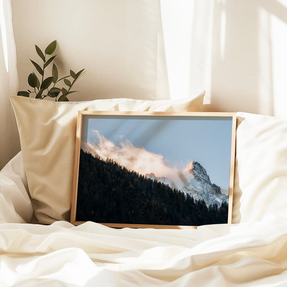 Aiguille du Midi wall art print with warm golden light and forested slope under a soft blue sky.