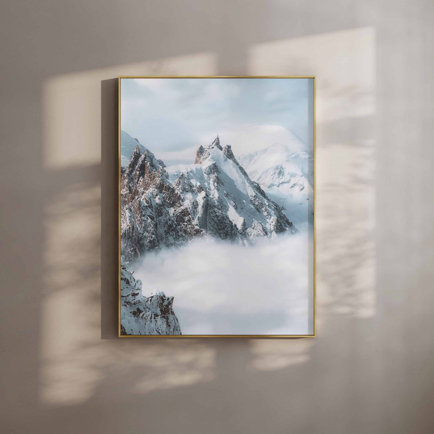 The iconic Aiguille du Midi peak surrounded by a dramatic mist-filled alpine backdrop.