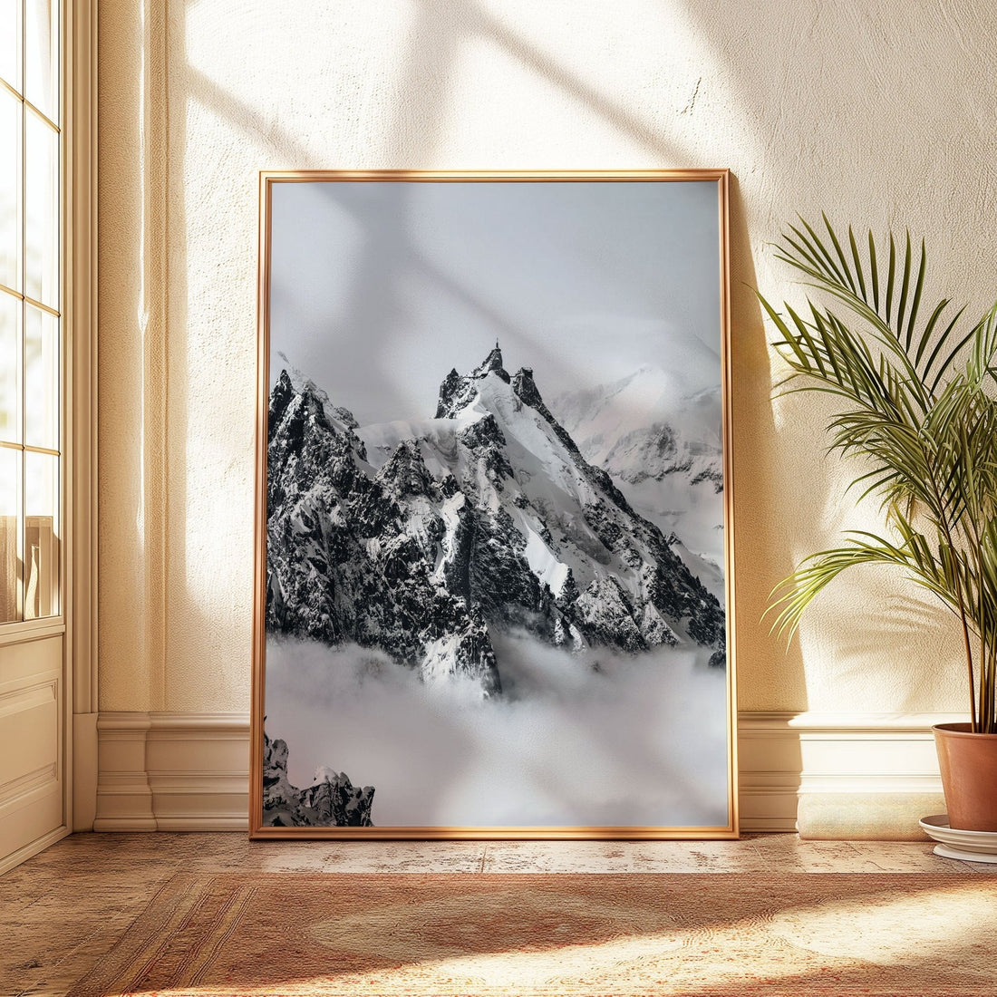 Iconic Aiguille du Midi mountain range shrouded in mist and snow, captured with serene detail in a wooden frame.