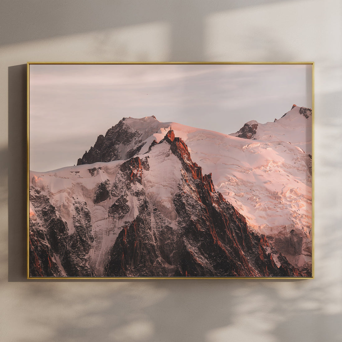 Fine art photography print of Aiguille du Midi at sunset, glowing with alpine light above Chamonix, France.
