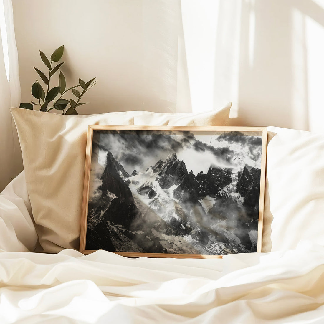 Atmospheric black and white photo print of Aiguille du Plan piercing the clouds above the Chamonix Valley.