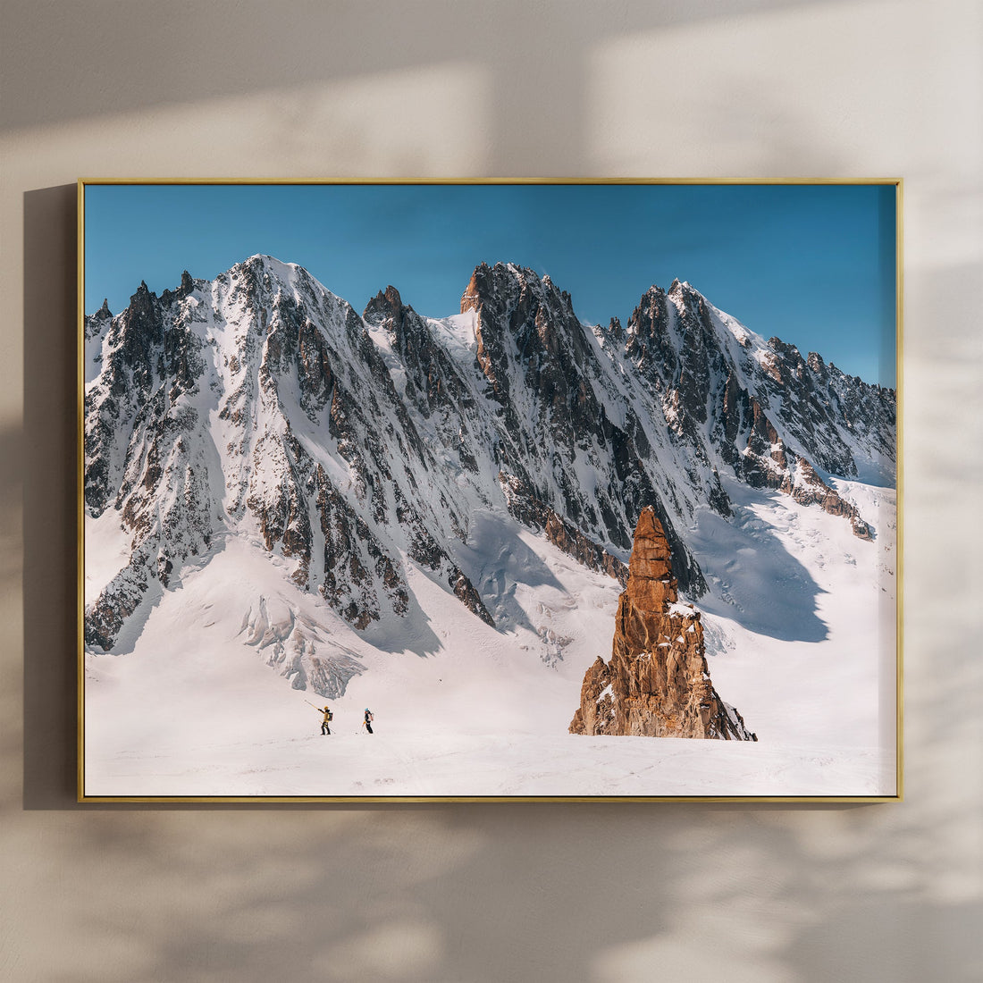 Dramatic Alps wall art print of two ski tourers crossing Argentière Glacier beneath Aiguille Verte peaks.