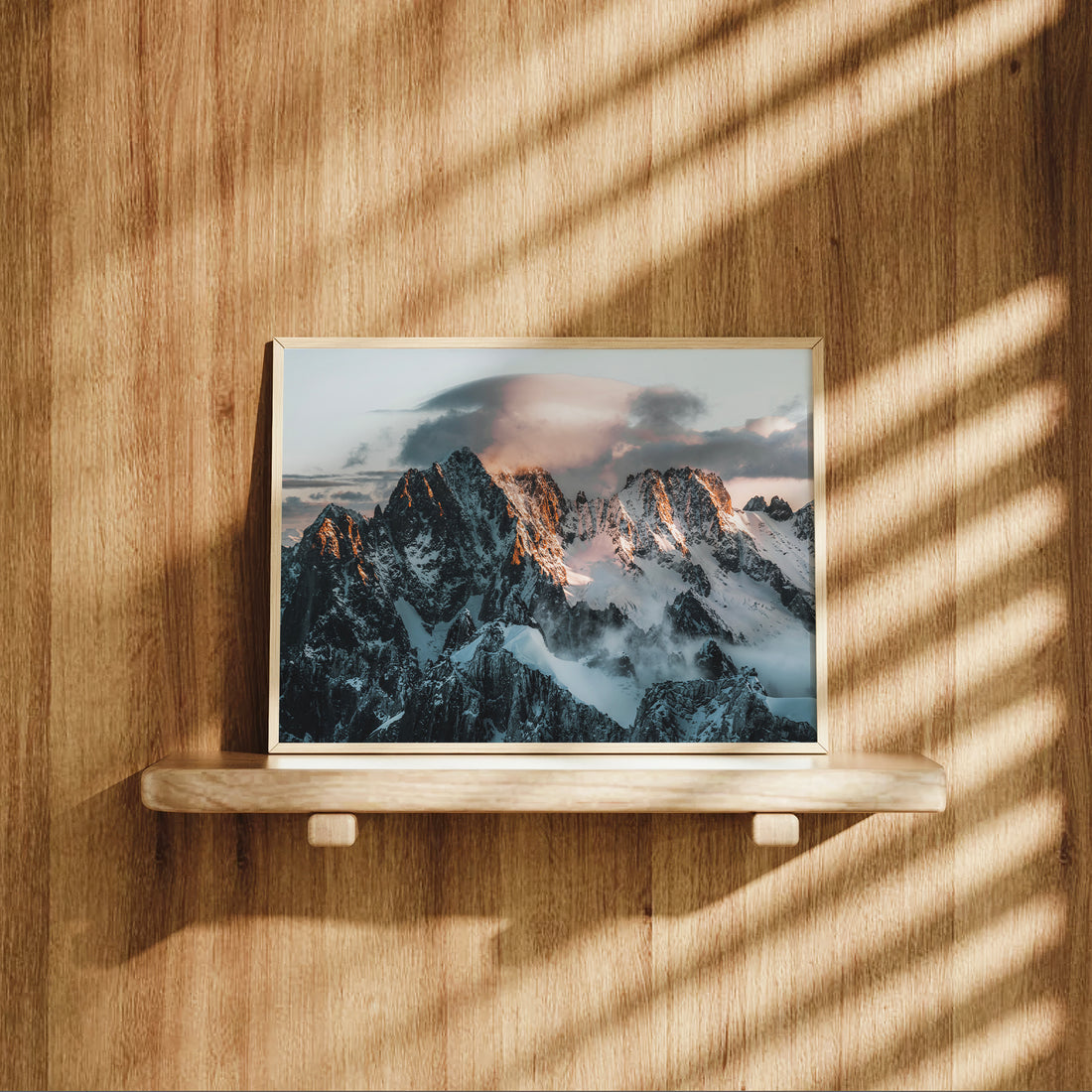 Aiguille Verte sunrise mountain print displayed on wooden shelf, alpine photography wall art