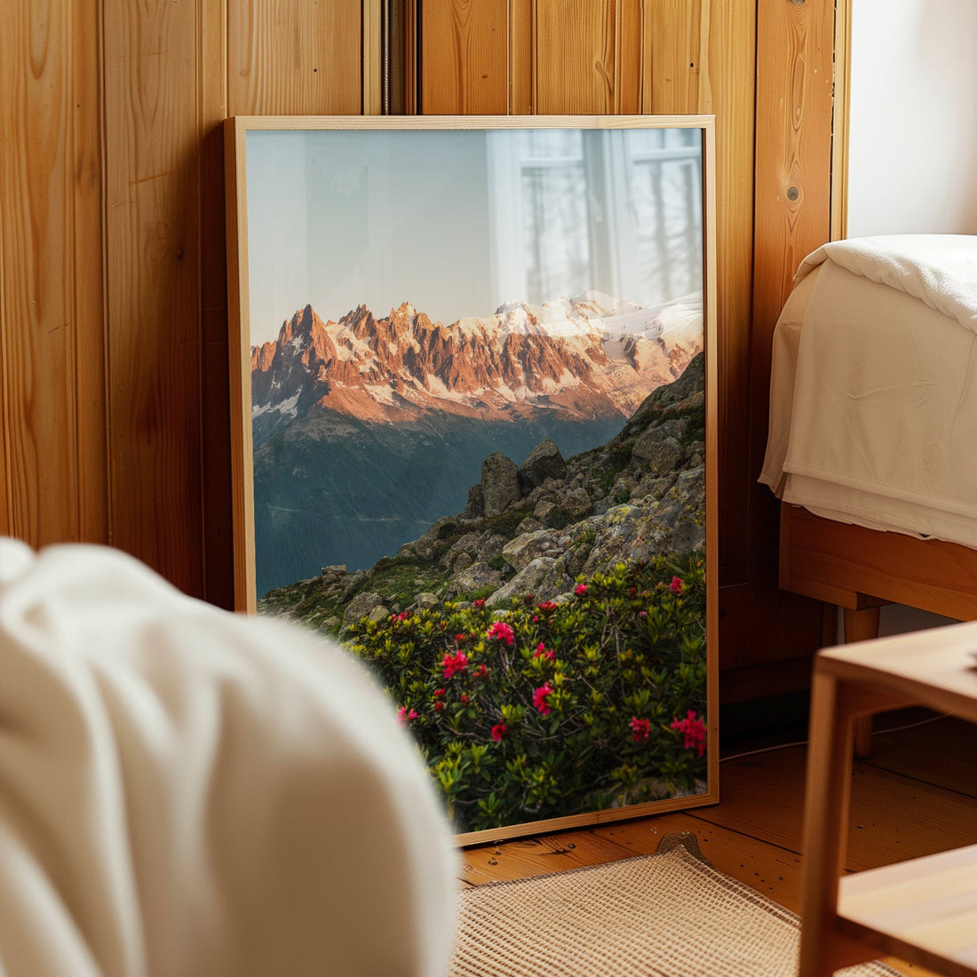 A serene landscape print of Aiguilles de Chamonix with blooming wildflowers under a golden sunset.