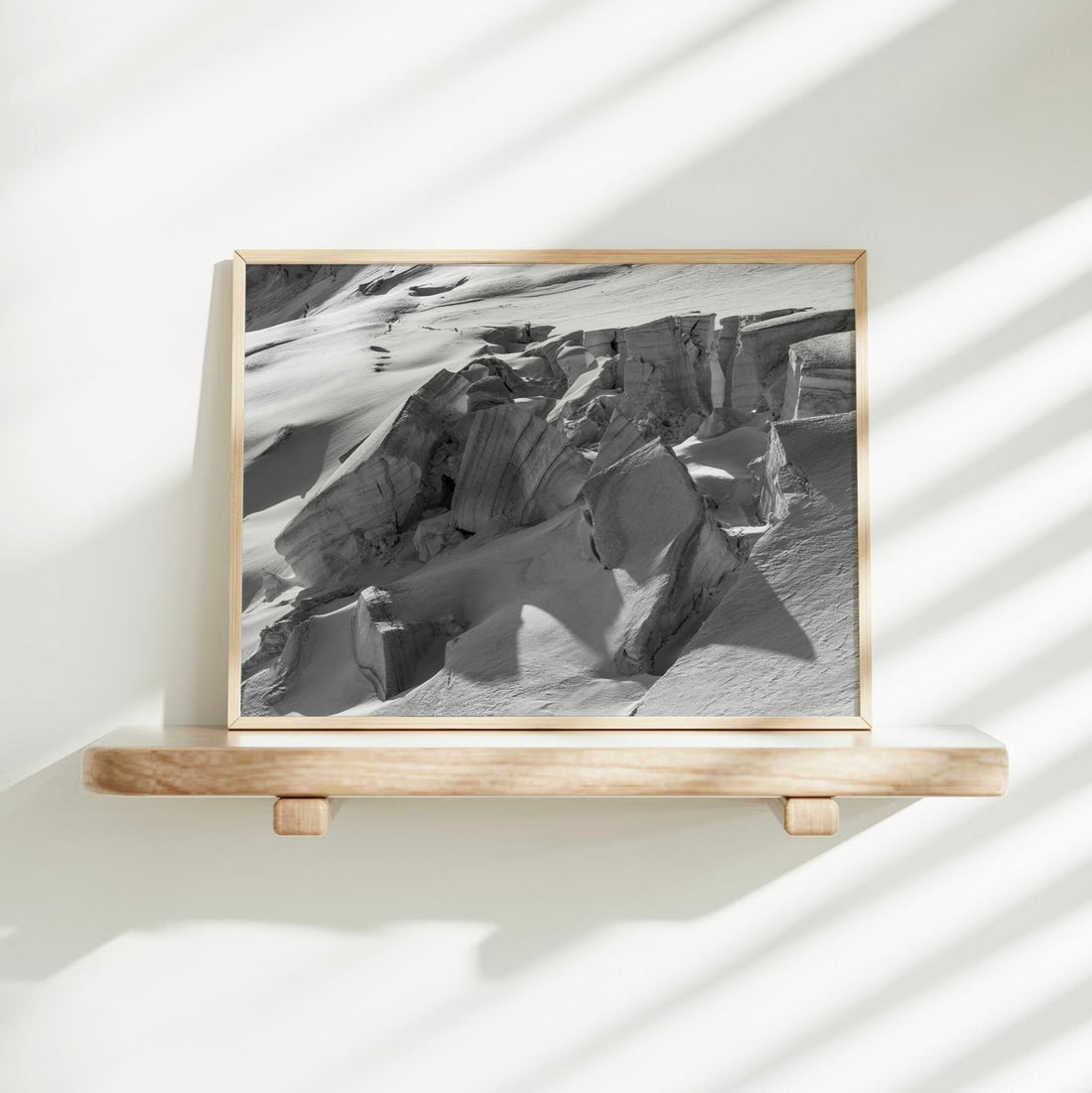 Alpine glacier crevasse photo in black and white, showcasing dramatic natural shapes and high-altitude terrain.