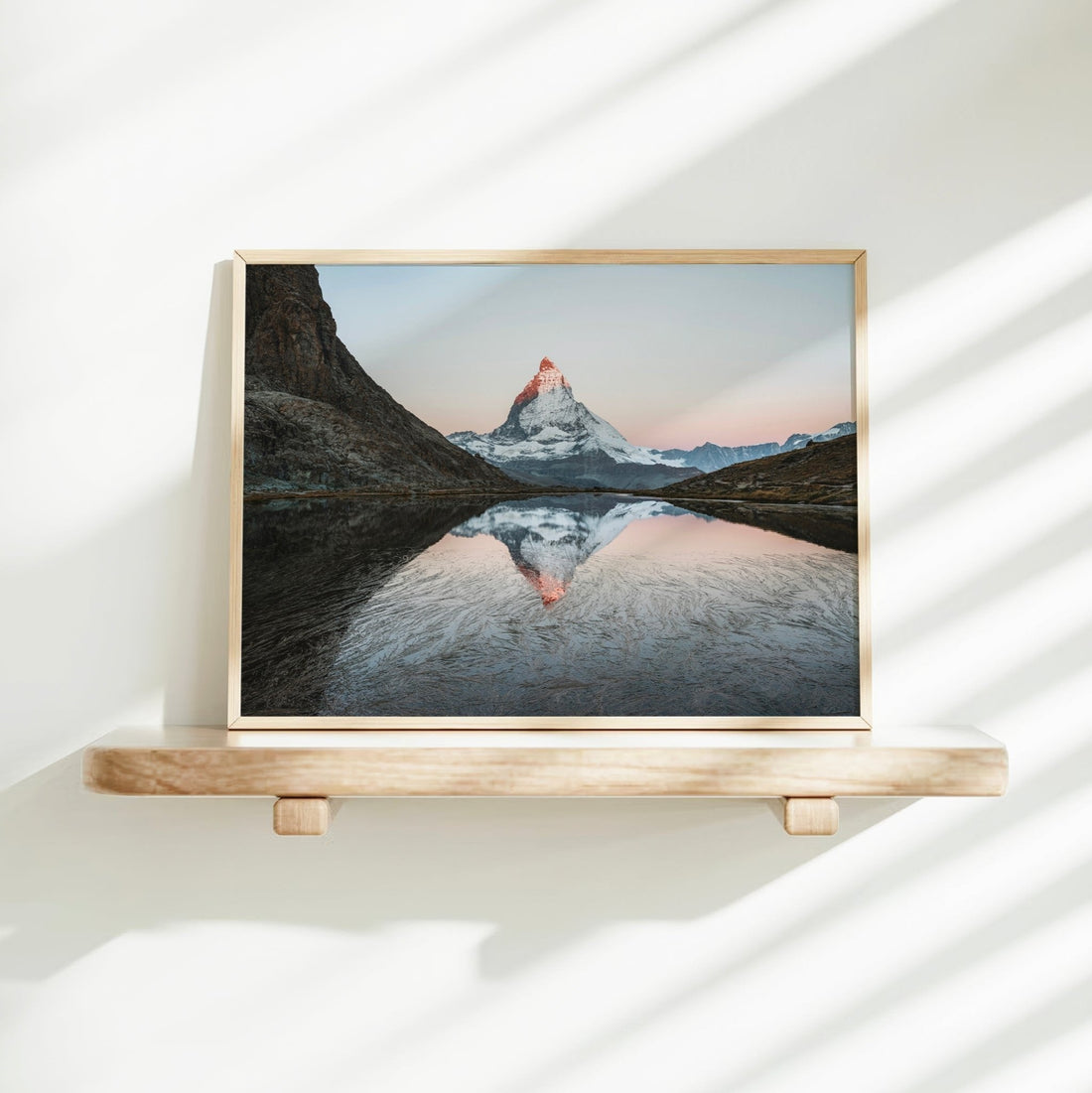 Striking alpine dawn photography print of the Matterhorn glowing in soft morning light over a still lake.