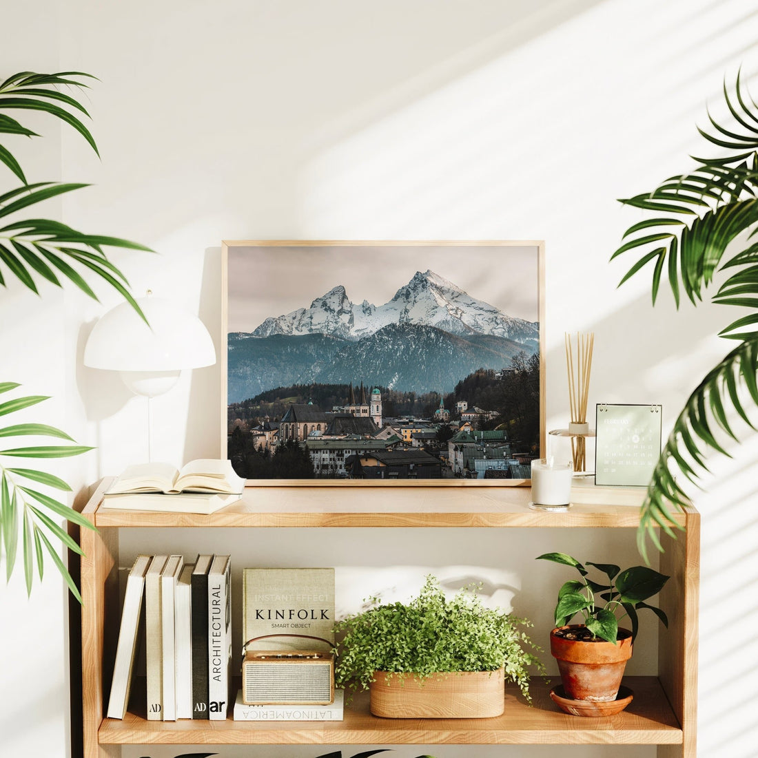 Mountain village print of Berchtesgaden styled on shelf with books and plants