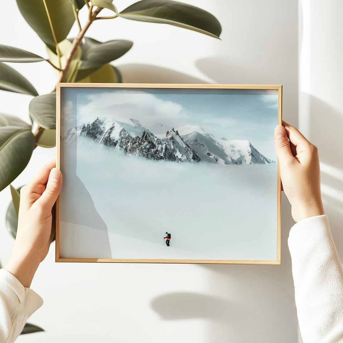 Captivating Mont Blanc alpine expedition photo with a solitary ski mountaineer against dramatic snowy peaks.