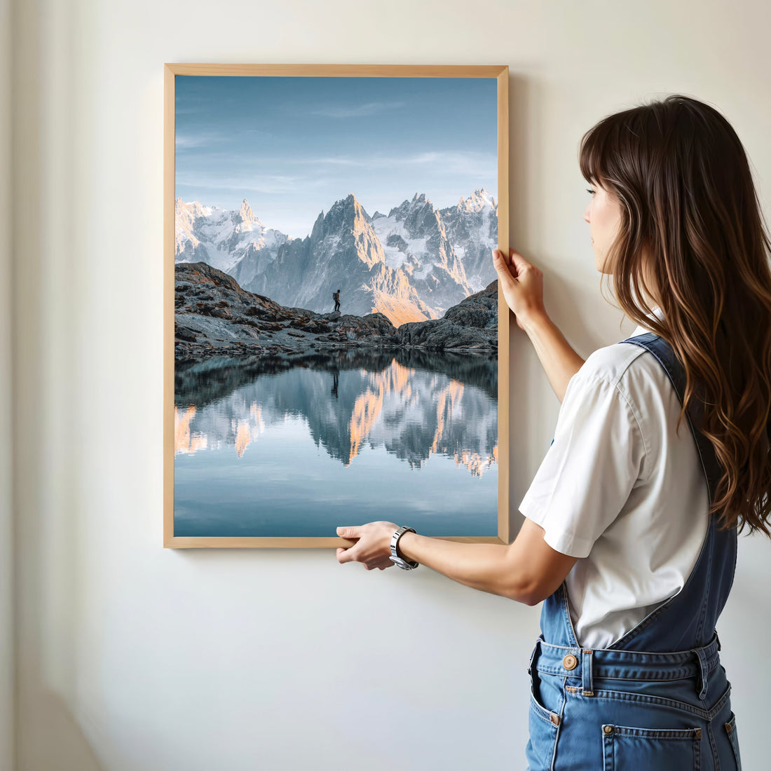 A lone hiker stands at Lac Blanc, gazing at the dramatic peaks of Mont Blanc in this scenic wall art.