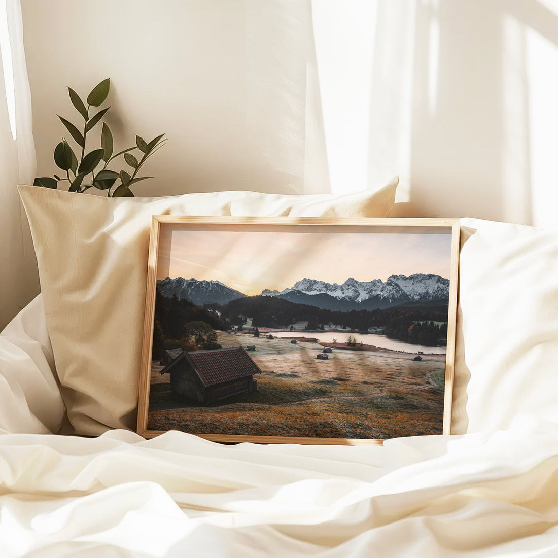 Scenic huts beside Geroldsee lake with snow-covered mountains in background