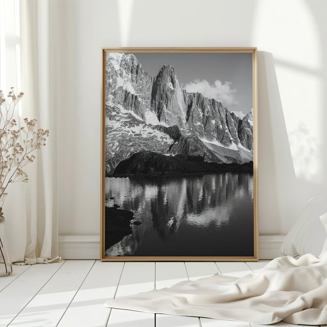 Scenic photography print of Les Drus reflecting in an alpine lake, creating a mesmerizing mountain view.