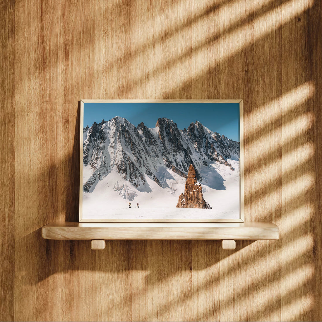 Framed Alps wall art featuring stunning snow-covered mountains and a towering spire in Chamonix, France.