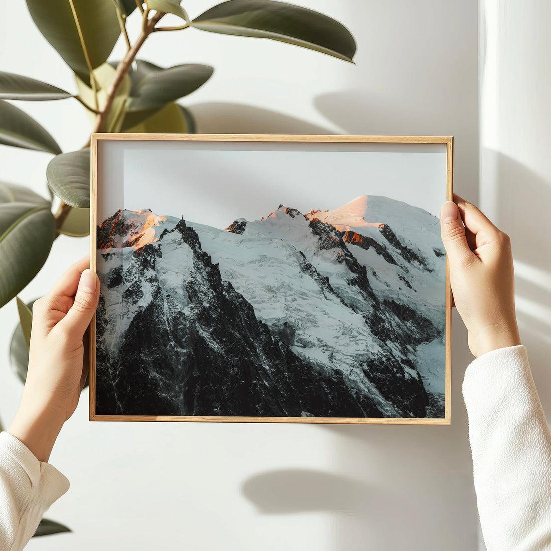 Framed art print of the dramatic Mont Blanc Massif during sunset, with warm glow over glacial cliffs.