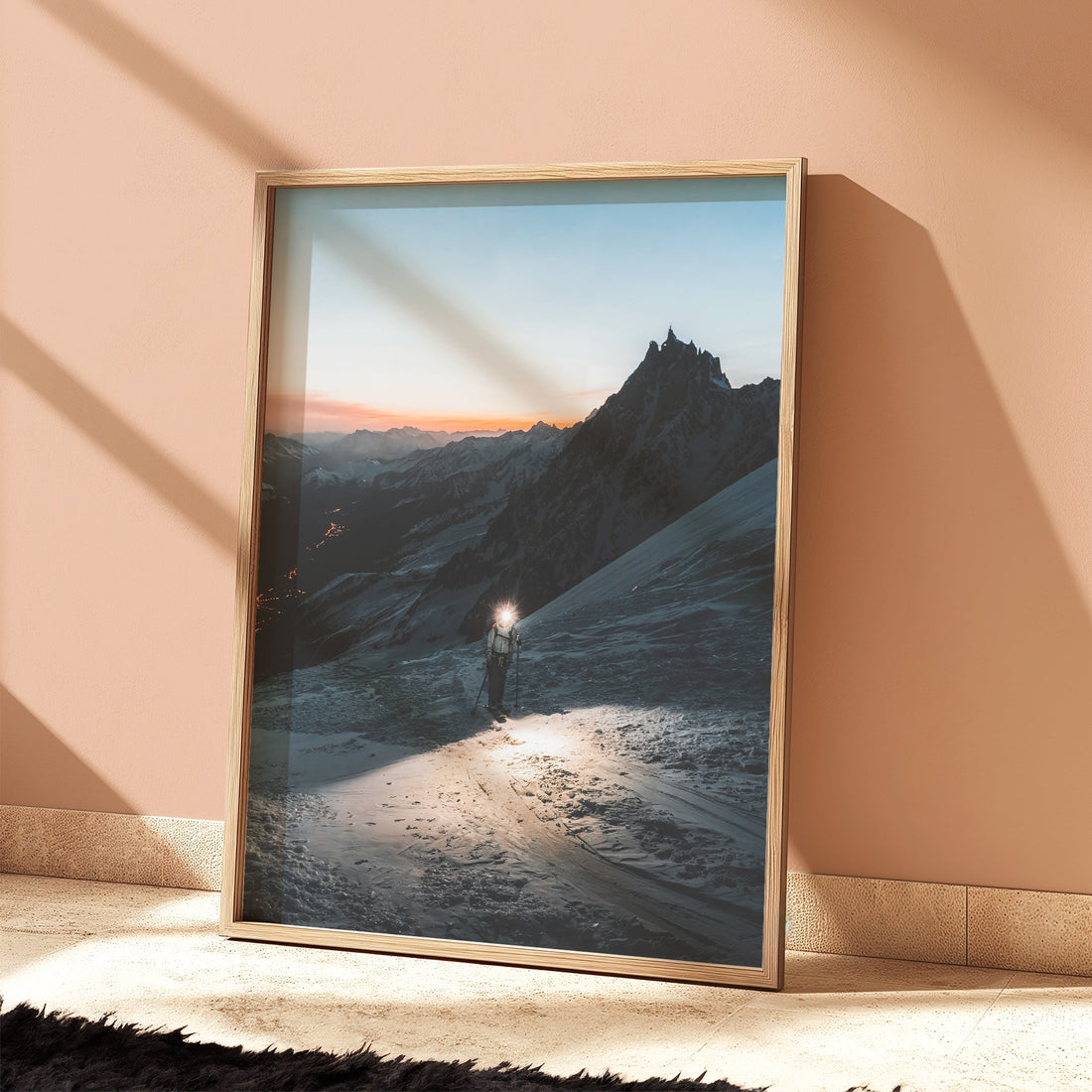 Elegant light room with framed snowy mountain print showing a lone climber