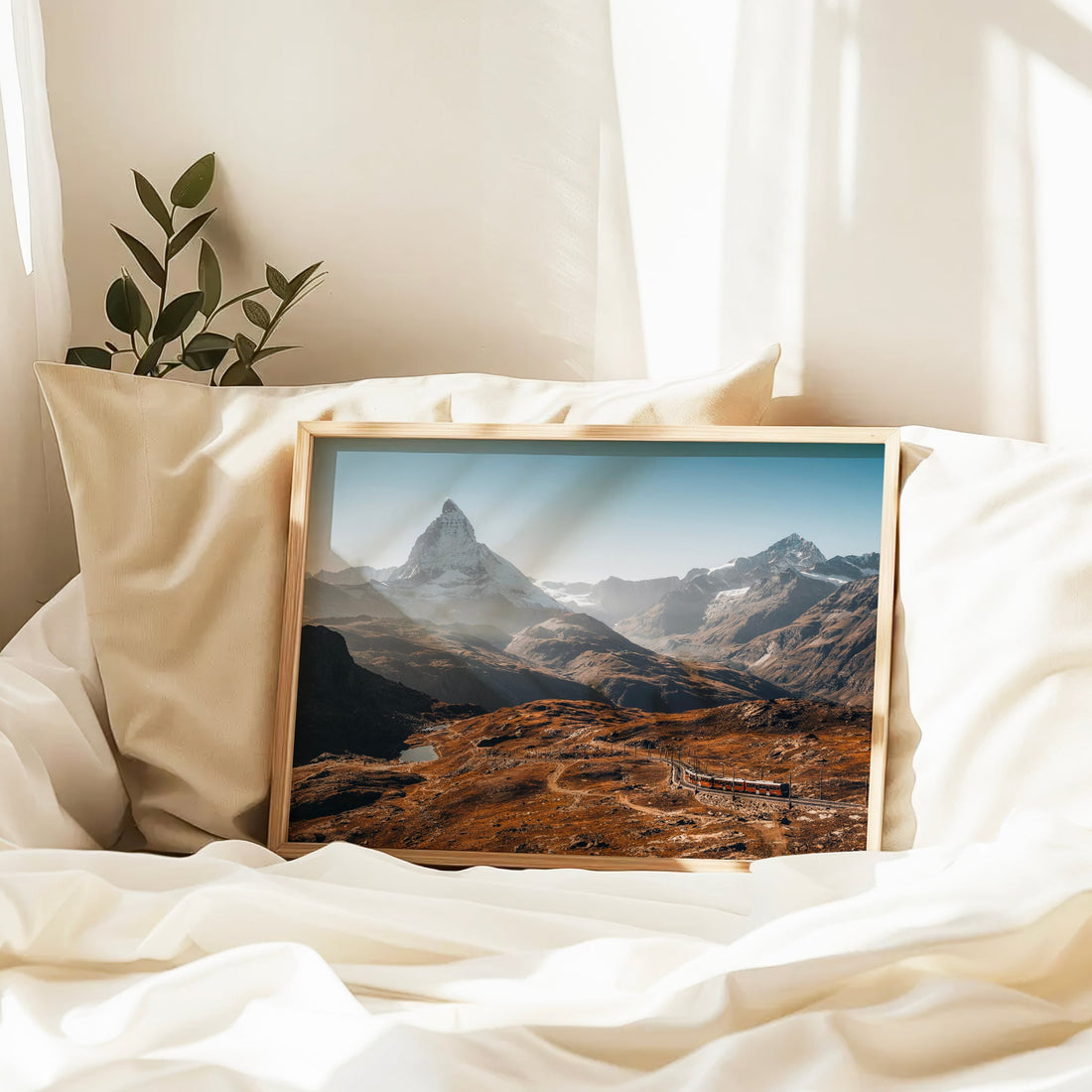 Swiss Alps landscape with the Matterhorn as a backdrop and the Gornergrat Railway winding through the valley.