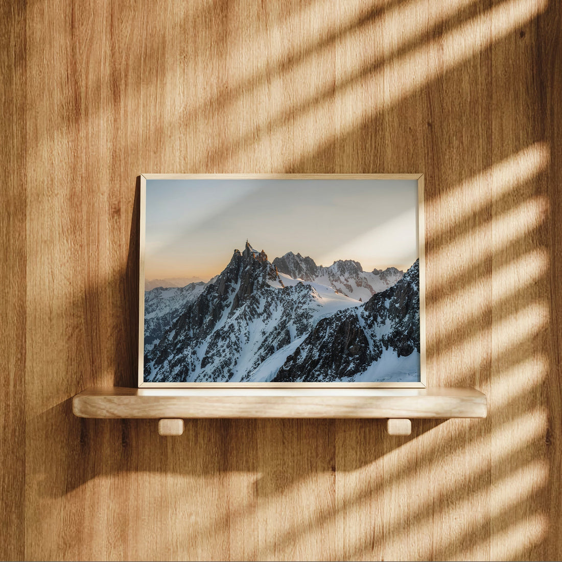 Alpine ridge landscape print showing Aiguille du Midi rising over Chamonix with morning light and snowy ridges.