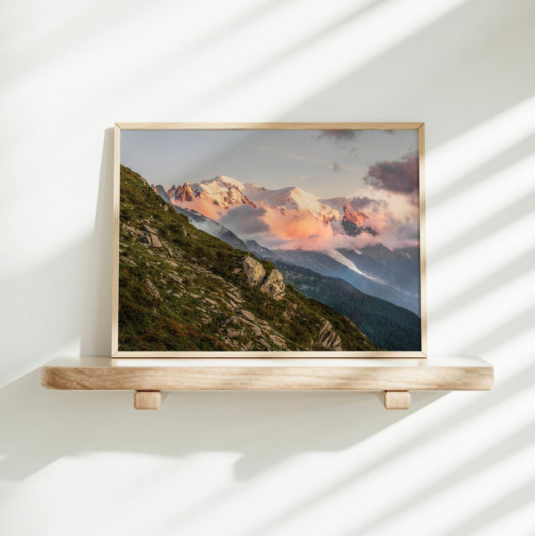Alpine sunset wall art with a radiant Mont Blanc skyline framed by rugged foreground greenery