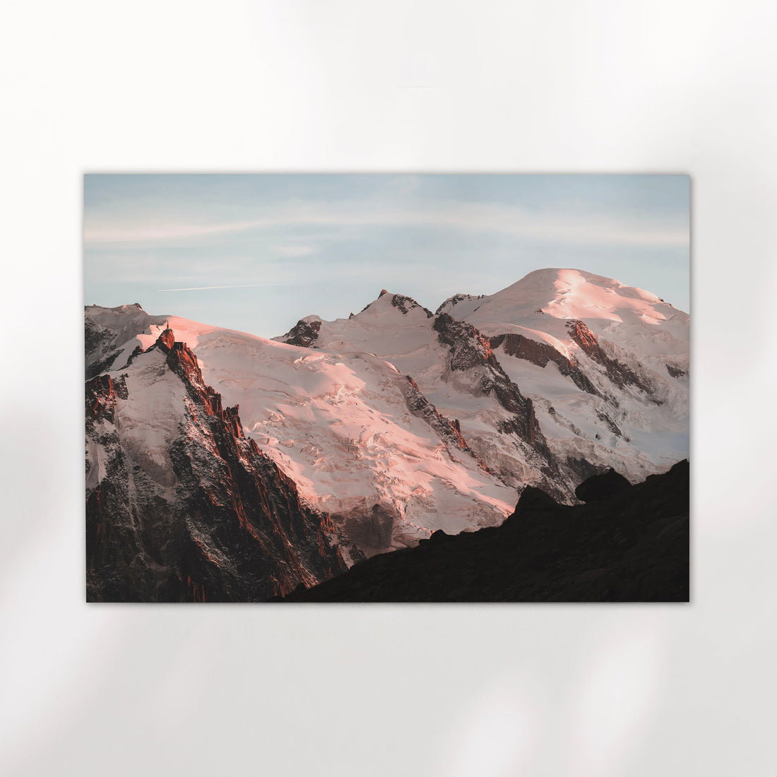 Wall art of Mont Blanc’s glacier-covered ridges glowing pink above Chamonix, perfect for modern decor.