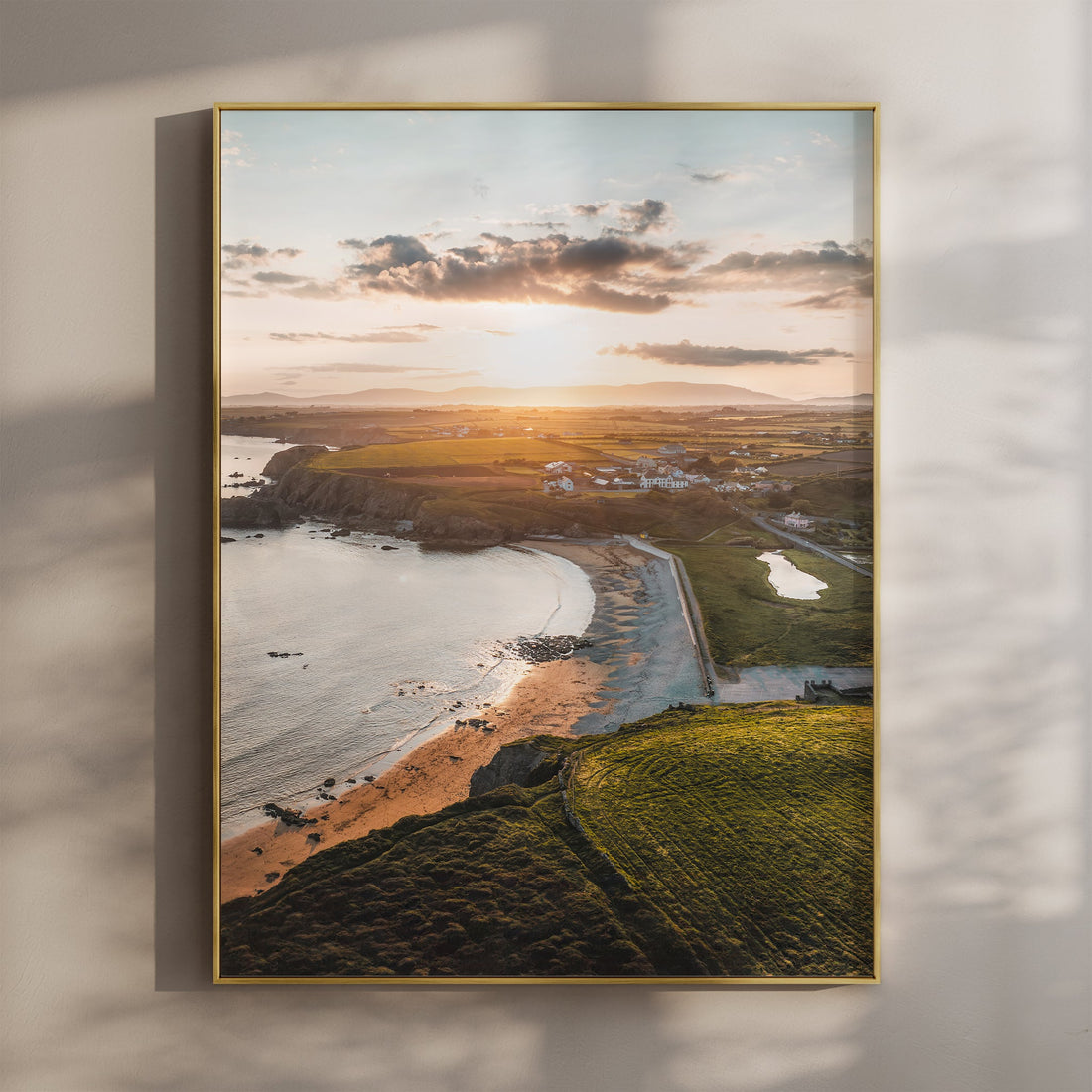 Framed aerial print of Annestown Beach at sunset with glowing light on the Irish coastline
