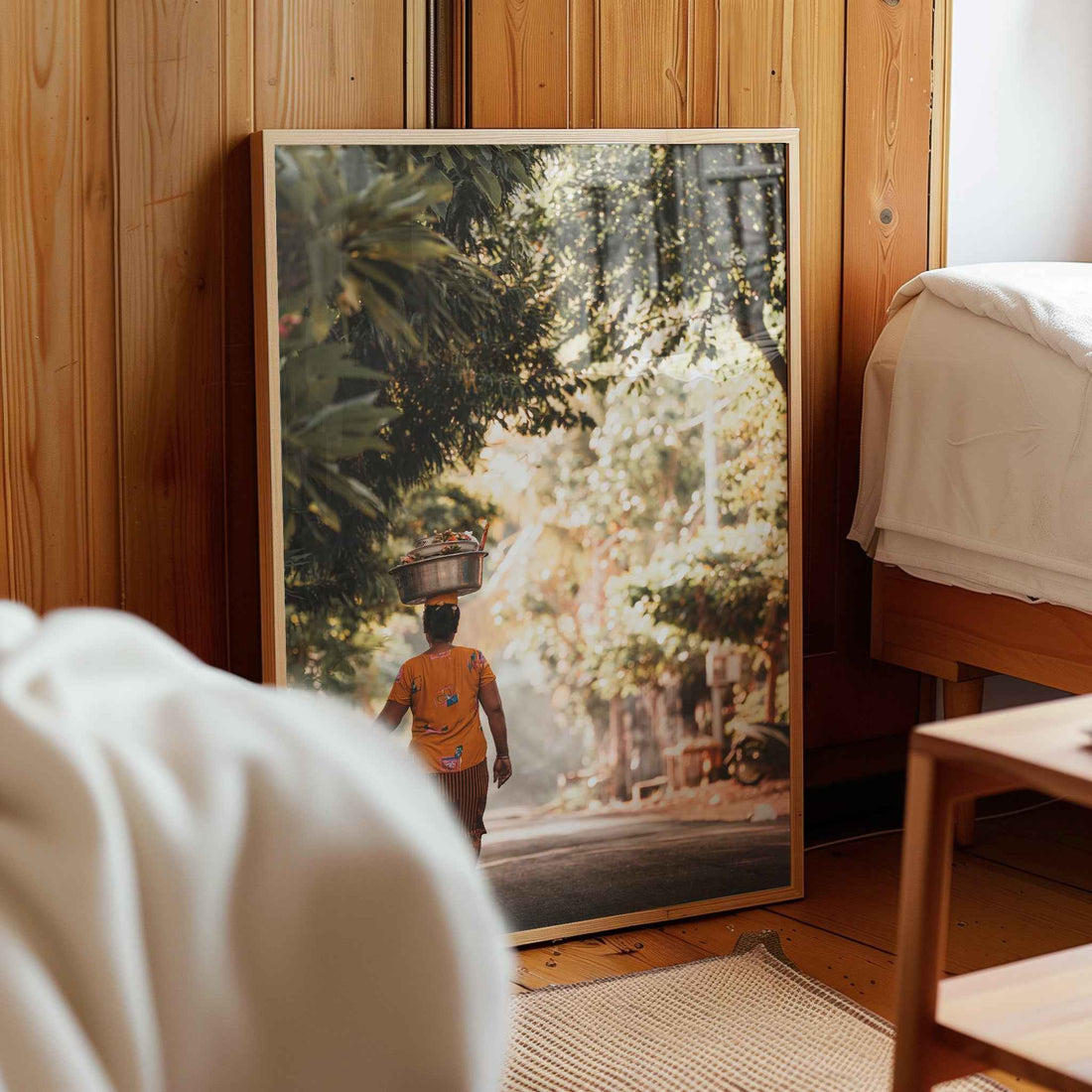 Balinese woman carrying offerings framed photography print leaning against wooden wall in cosy bedroom interior