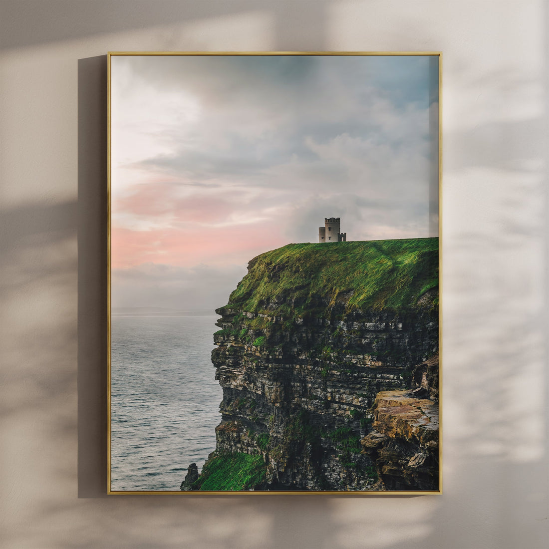 Wall art print of the Cliffs of Moher at sunset with a stone tower overlooking the Atlantic Ocean