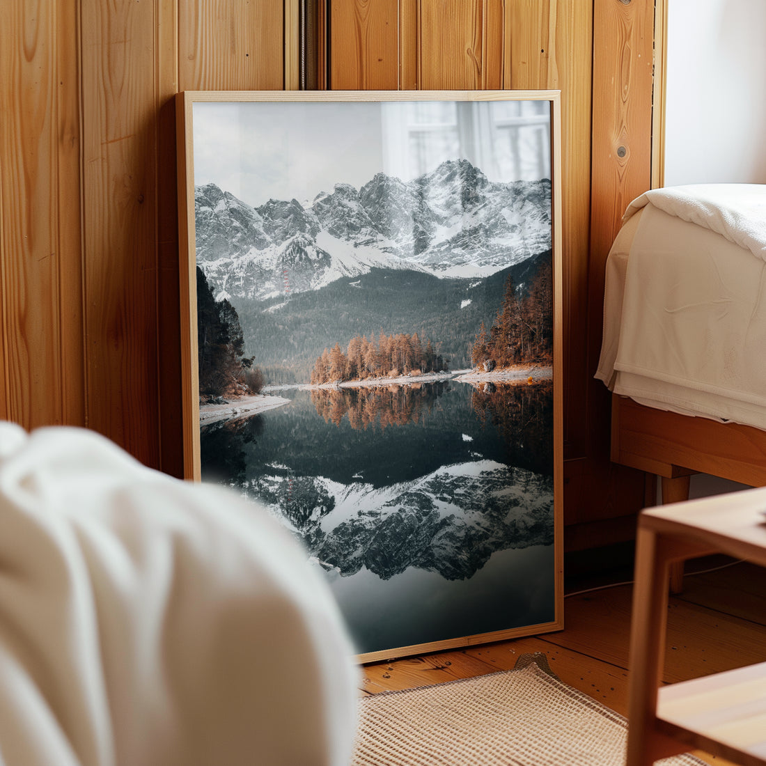 Eibsee photography print leaning against a wooden wall in a bedroom