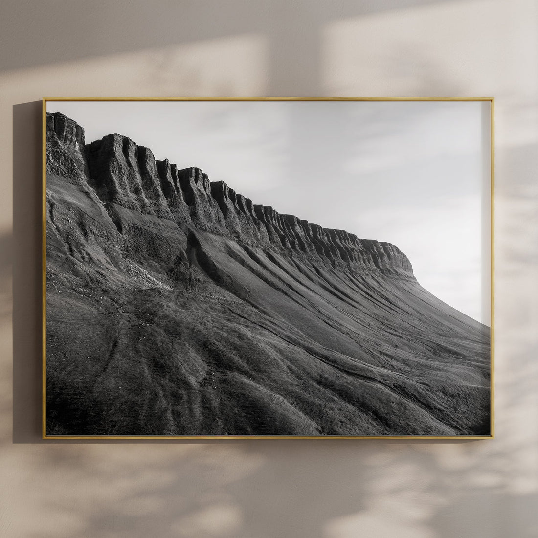 Black and white photo print of Benbulbin mountain in a gold frame on a wall