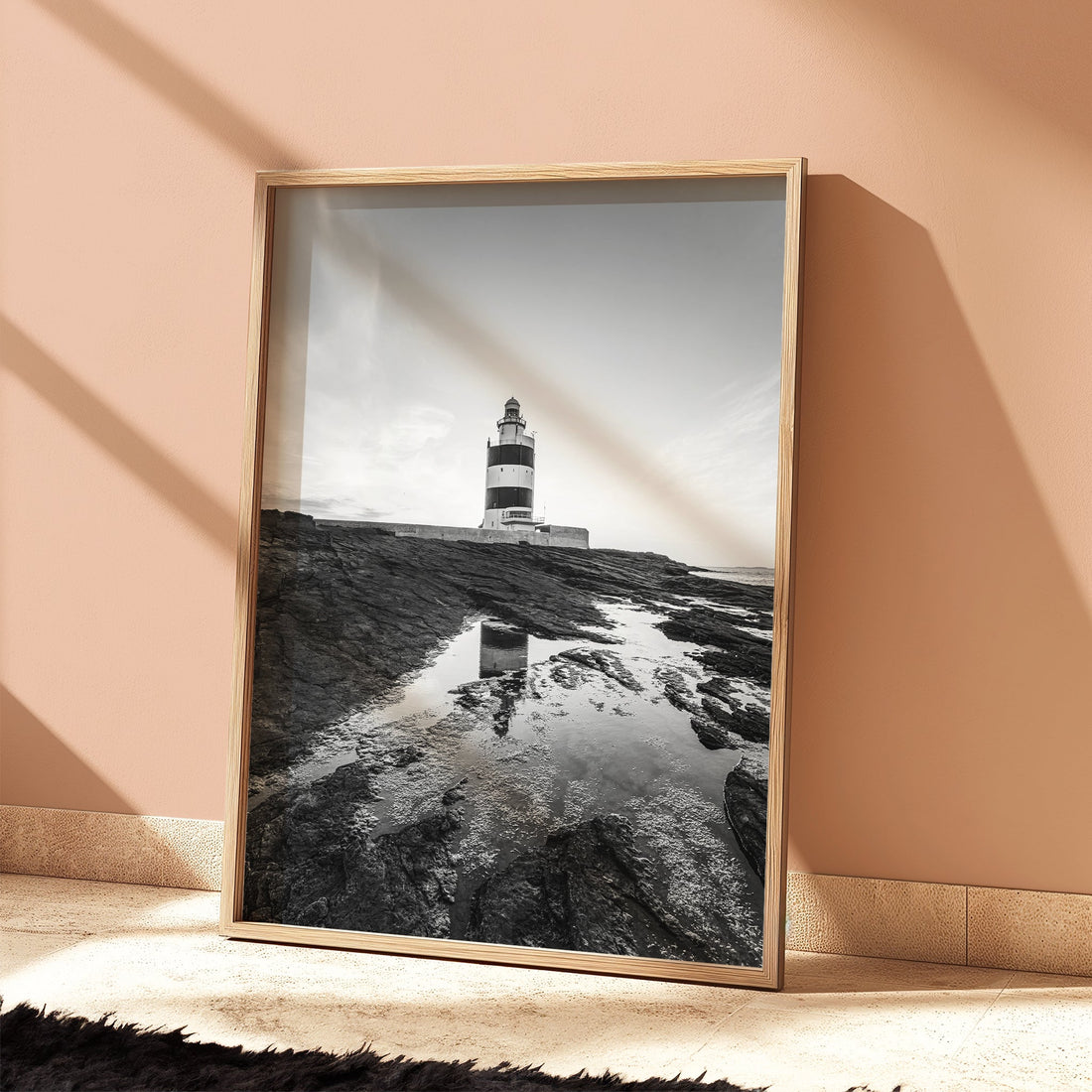 Poster of Hook Lighthouse in wooden frame with warm peach background