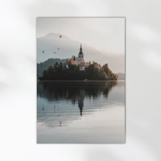 Peaceful view of Lake Bled island and misty Alps in soft morning light