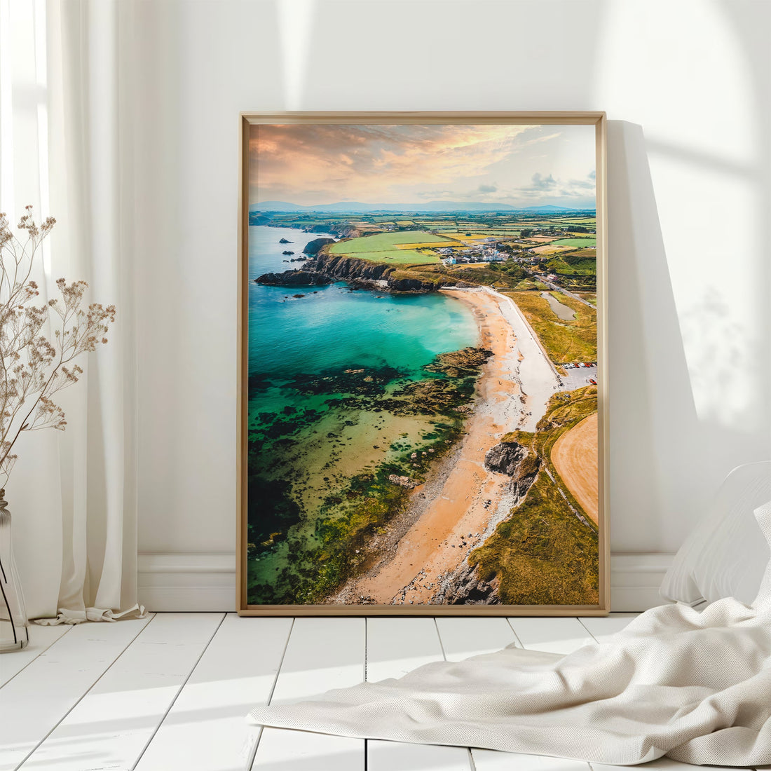 Framed Irish coastline print of Annestown Beach on white wooden floor