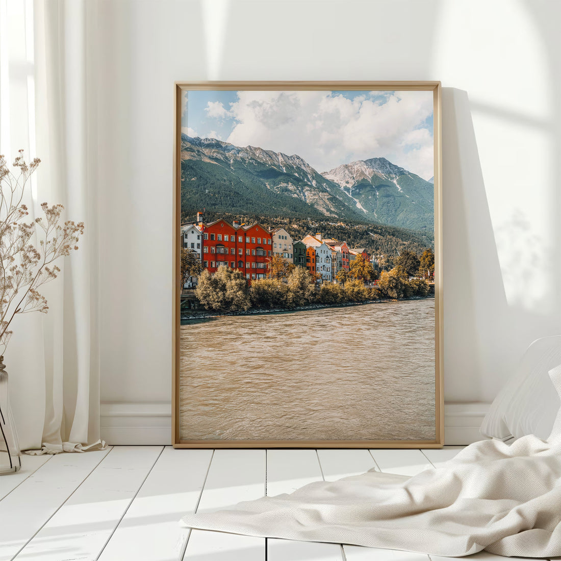 Cosy living room with Innsbruck print of riverside houses and Tyrolean mountains.