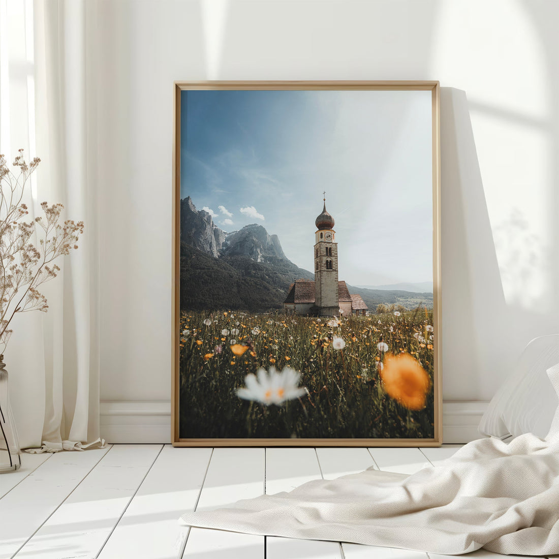 Alpine church art print with wildflowers framed in a minimalist sunlit room