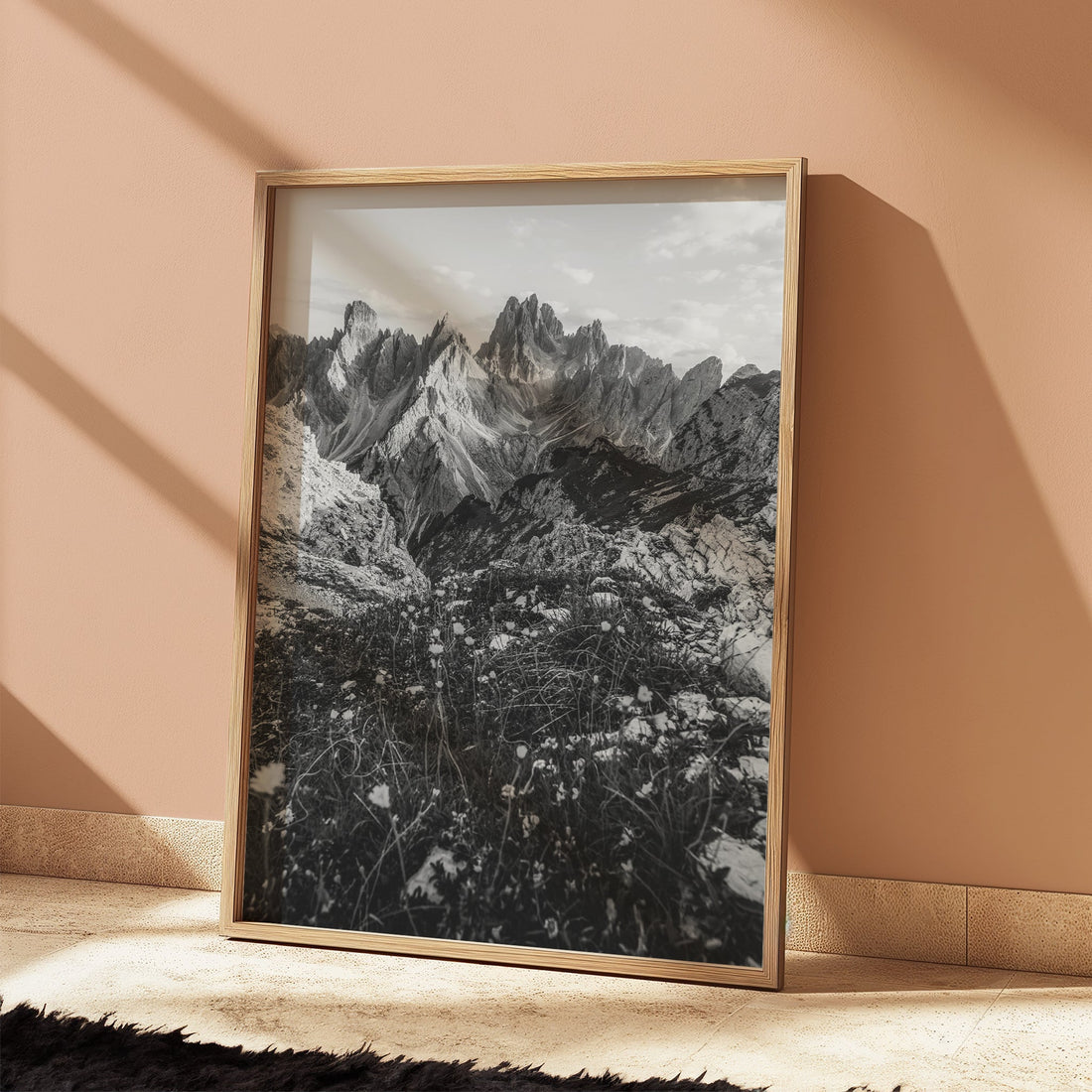 Monochrome photo print of Cadini di Misurina against a blush pink wall in natural light.