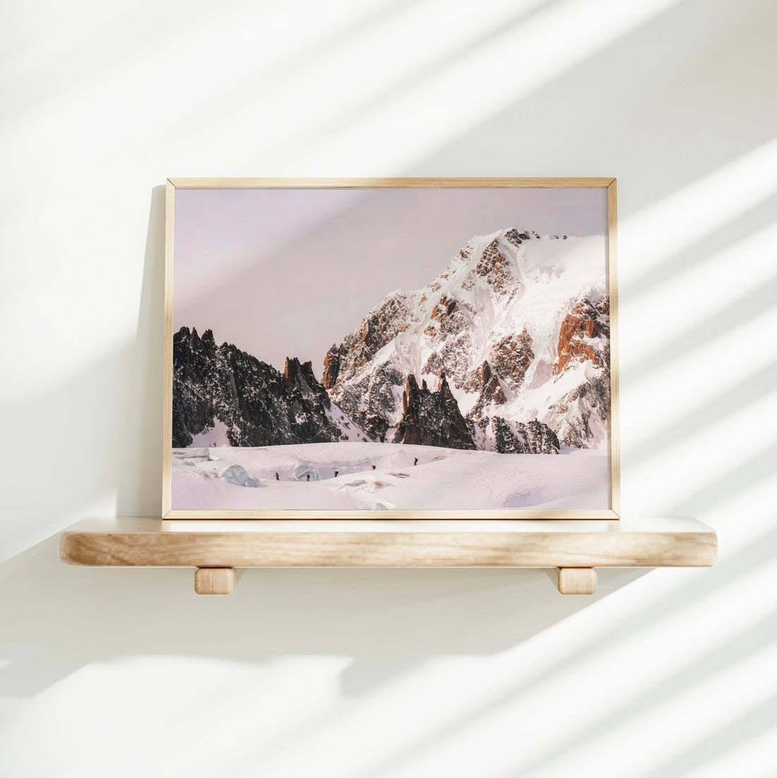 Chamonix alpine landscape photography print featuring a striking view of ski tourers against jagged peaks and untouched snow.