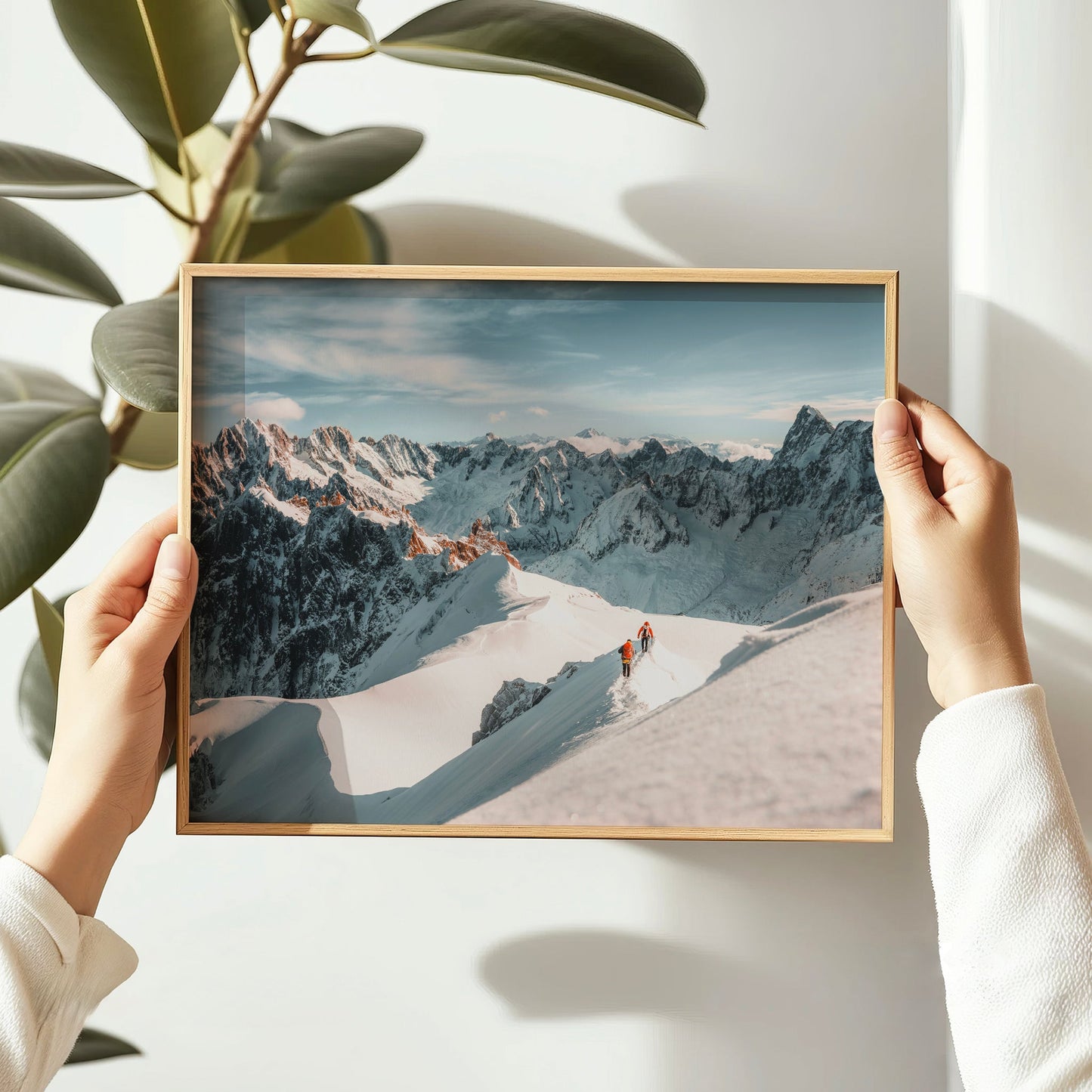 Chamonix wall art capturing two mountaineers trekking across the Aiguille du Midi’s snow-covered spine.