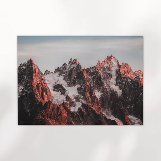 Modern wall art of the Chamonix Alps with dramatic Aiguilles peaks under a soft morning sky.