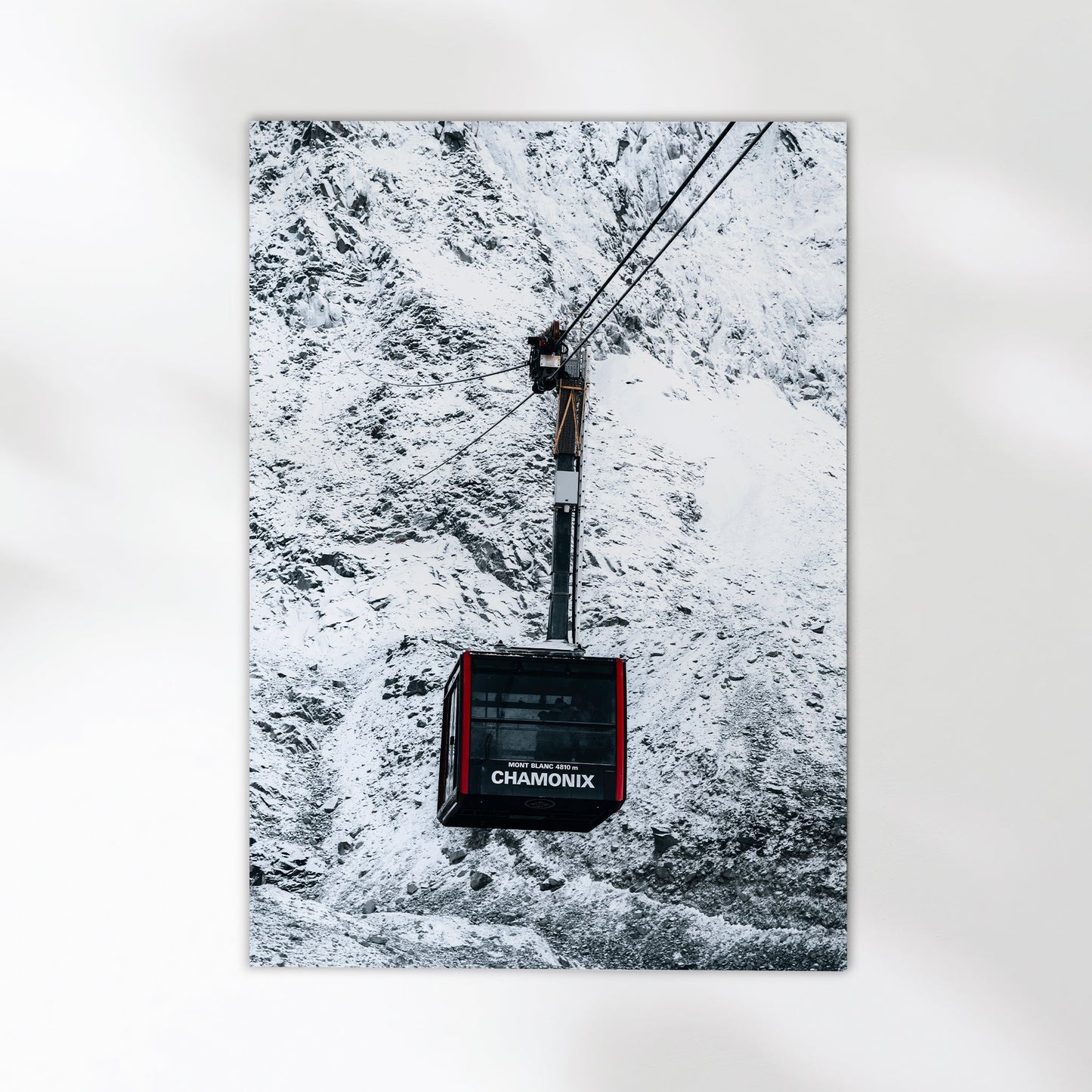 Chamonix cable car suspended above the stunning winter scenery of the French Alps.