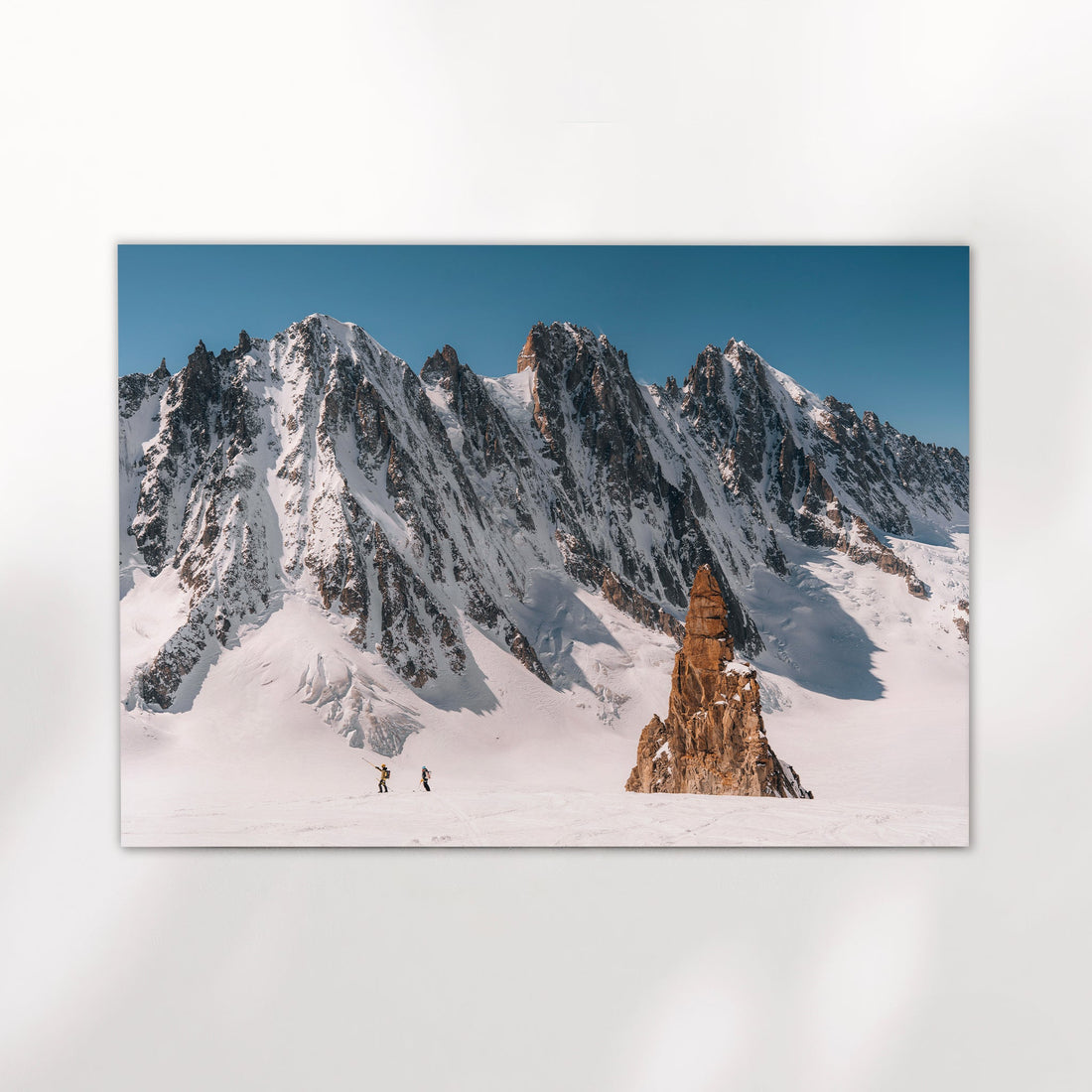 Fine art glacier photography print of ski tourers in Chamonix’s Argentière Basin with jagged alpine backdrop.