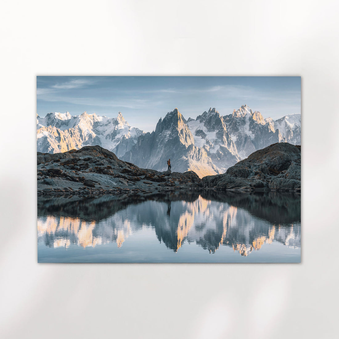 Chamonix photography print showing a hiker at Lac Blanc with crystal-clear reflections of the Alps.