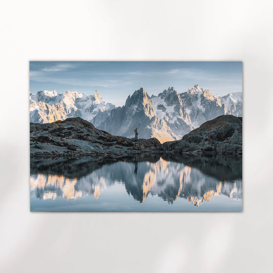 Chamonix photography print showing a hiker at Lac Blanc with crystal-clear reflections of the Alps.