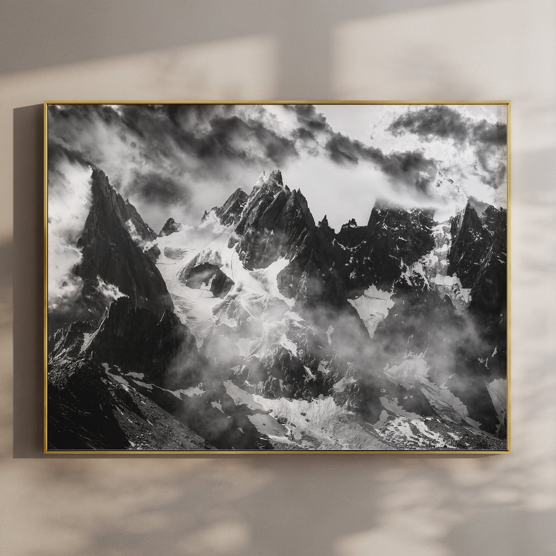 Dramatic black and white fine art print of the Aiguilles of Chamonix rising through clouds in the French Alps.