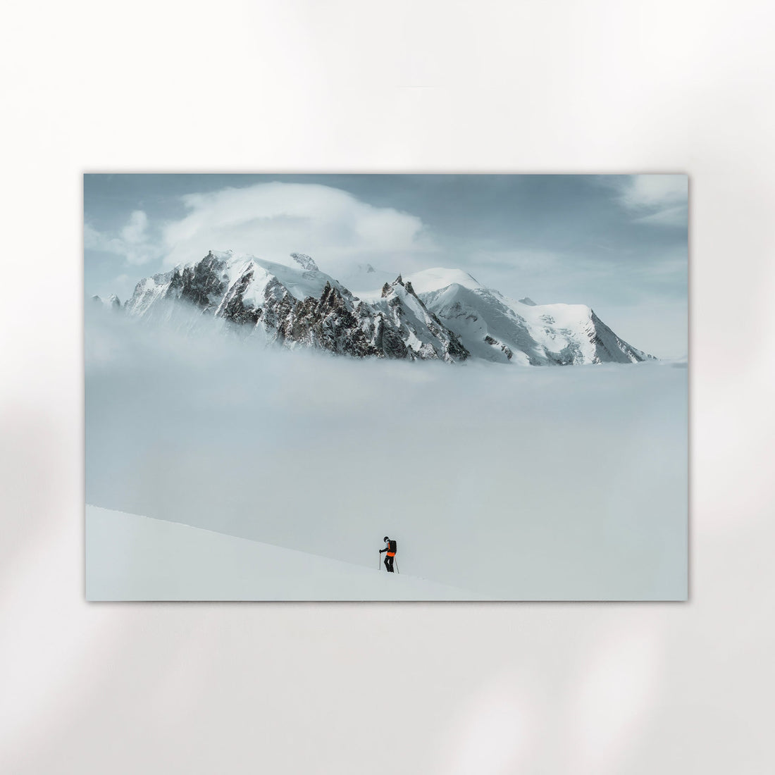Stunning Chamonix ski tour wall art print showcasing a skier on Mont Blanc with a sea of clouds below.