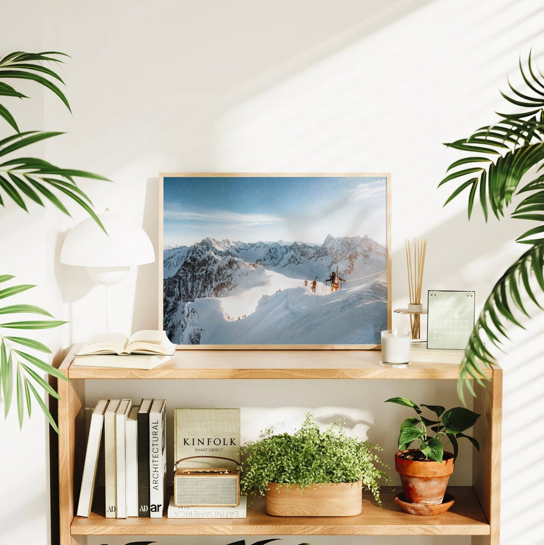 Framed photography print of skiers hiking through deep snow with Mont Blanc range in the background.