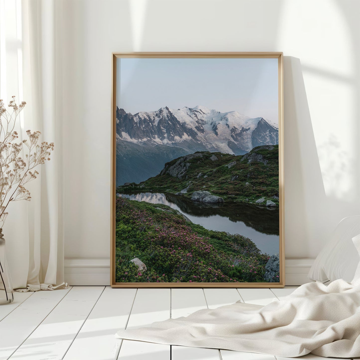Gorgeous Chamonix valley view with lush green slopes, a reflective lake, and the majestic Mont Blanc.