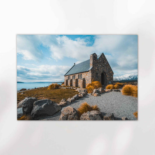 Unframed Church of the Good Shepherd fine art print on white background showing historic stone church beside Lake Tekapo with snow-capped mountains